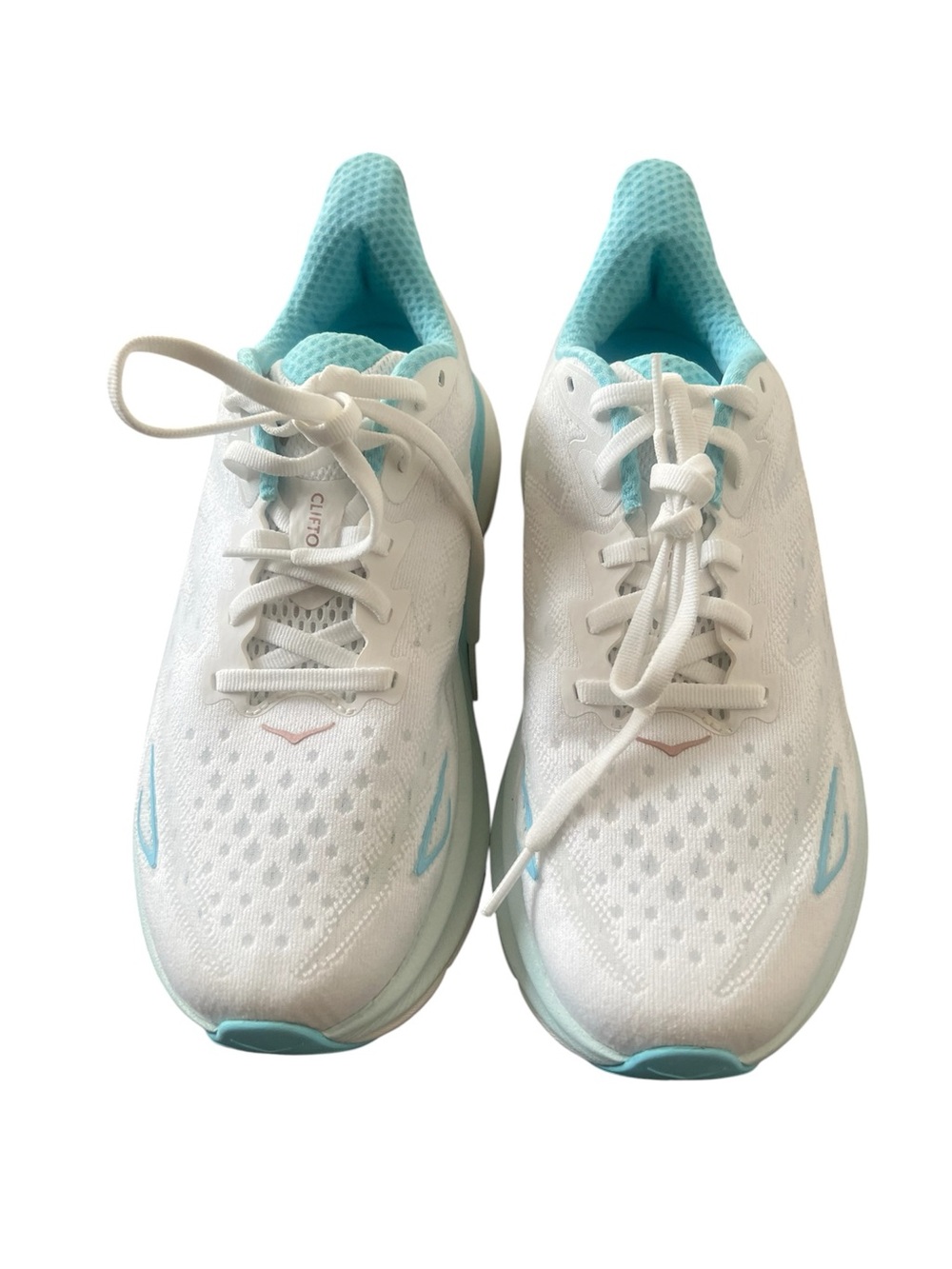 HOKA Women's Clifton 9 in the Frost / Rose Gold colorway, white mesh, sky blue.